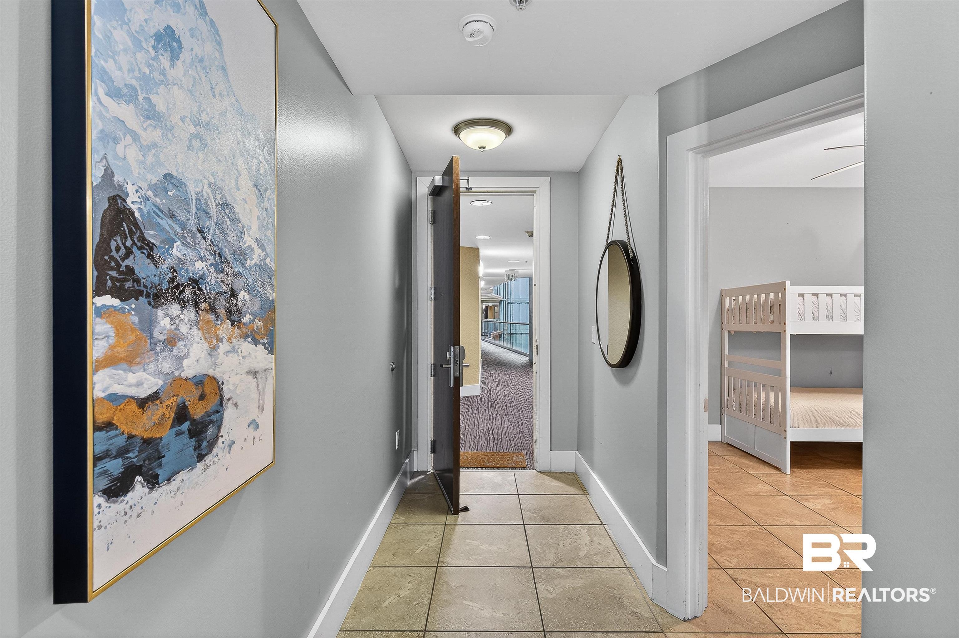 Image 3: Hallway featuring light tile patterned floors and baseboards