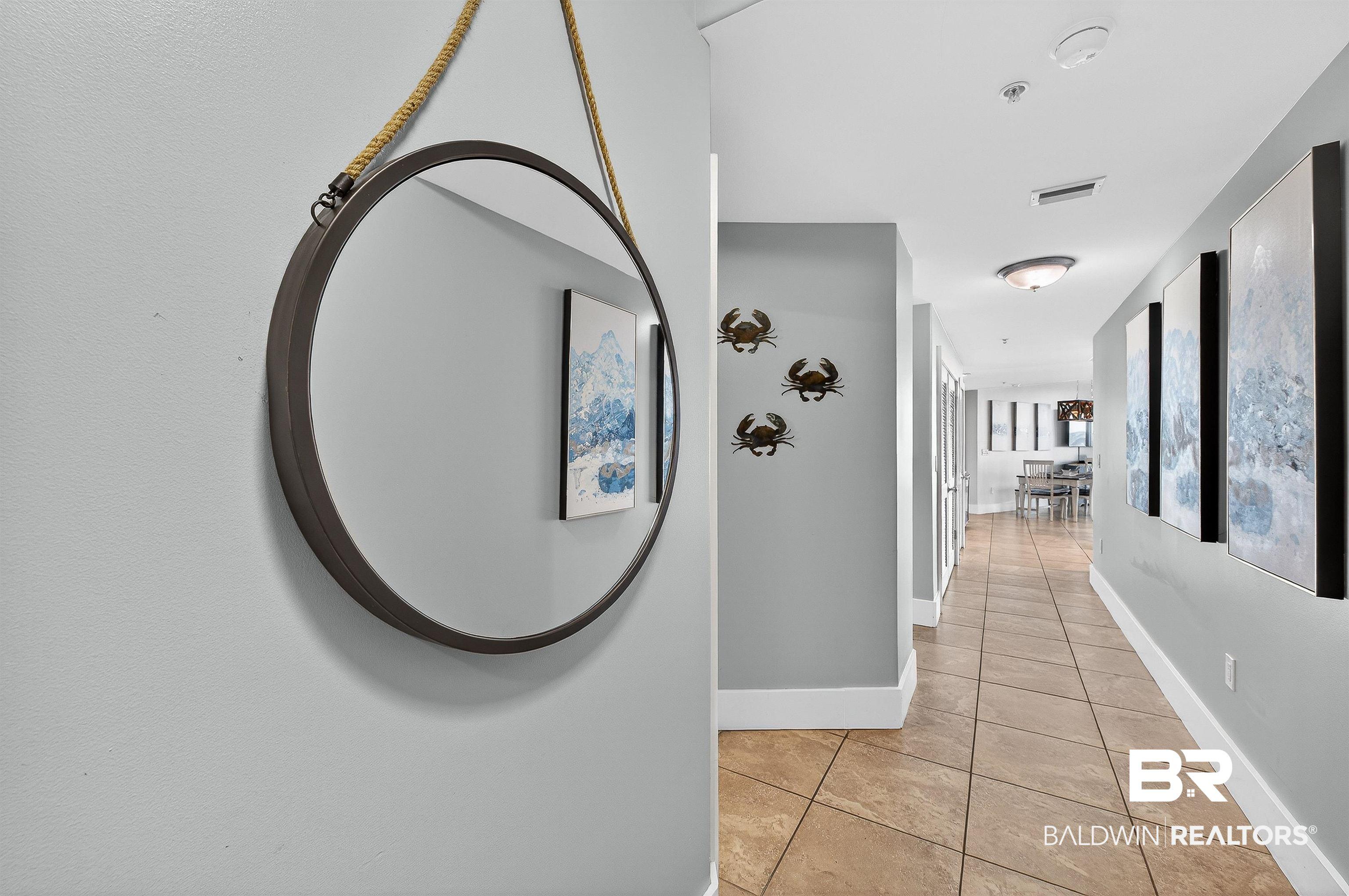 Image 4: Hallway featuring light tile patterned flooring and baseboards