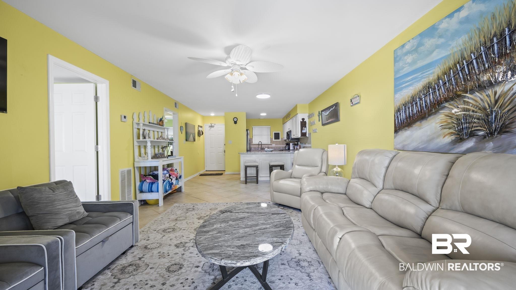 Image 3: Living area with recessed lighting, a ceiling fan, and light tile patterned floors