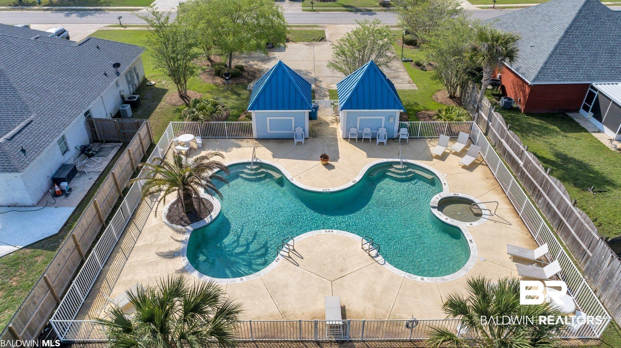 Image 2: Community pool with a patio