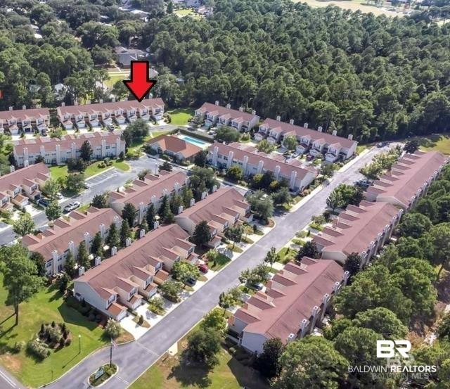 Image 2: Townhome community with multiple residential buildings, manicured green spaces, and mature tree lines