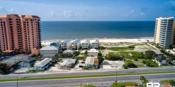 Image 2: Aerial view featuring a water view and a beach view