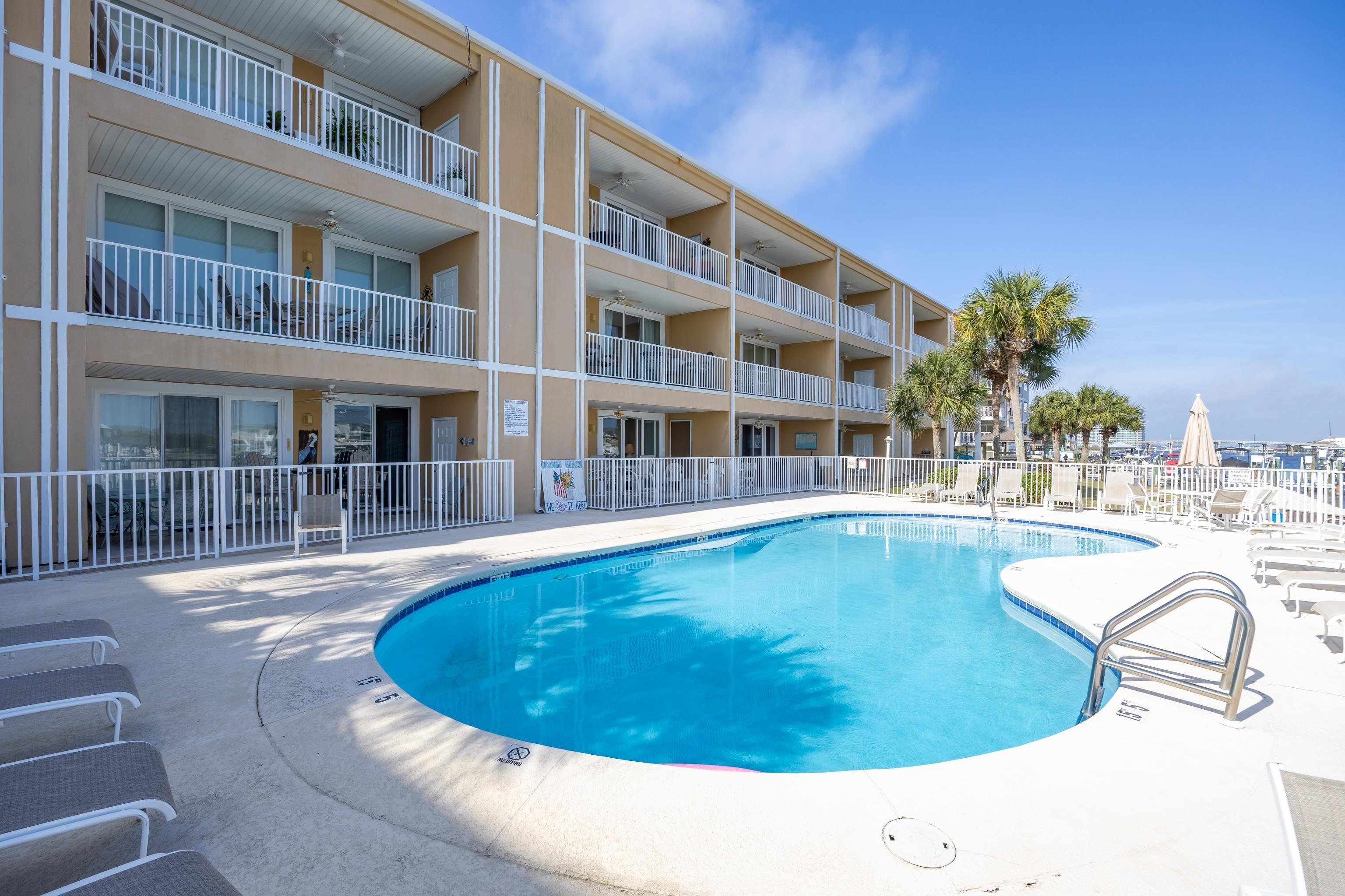 Image 2: Community pool featuring fence and a patio area