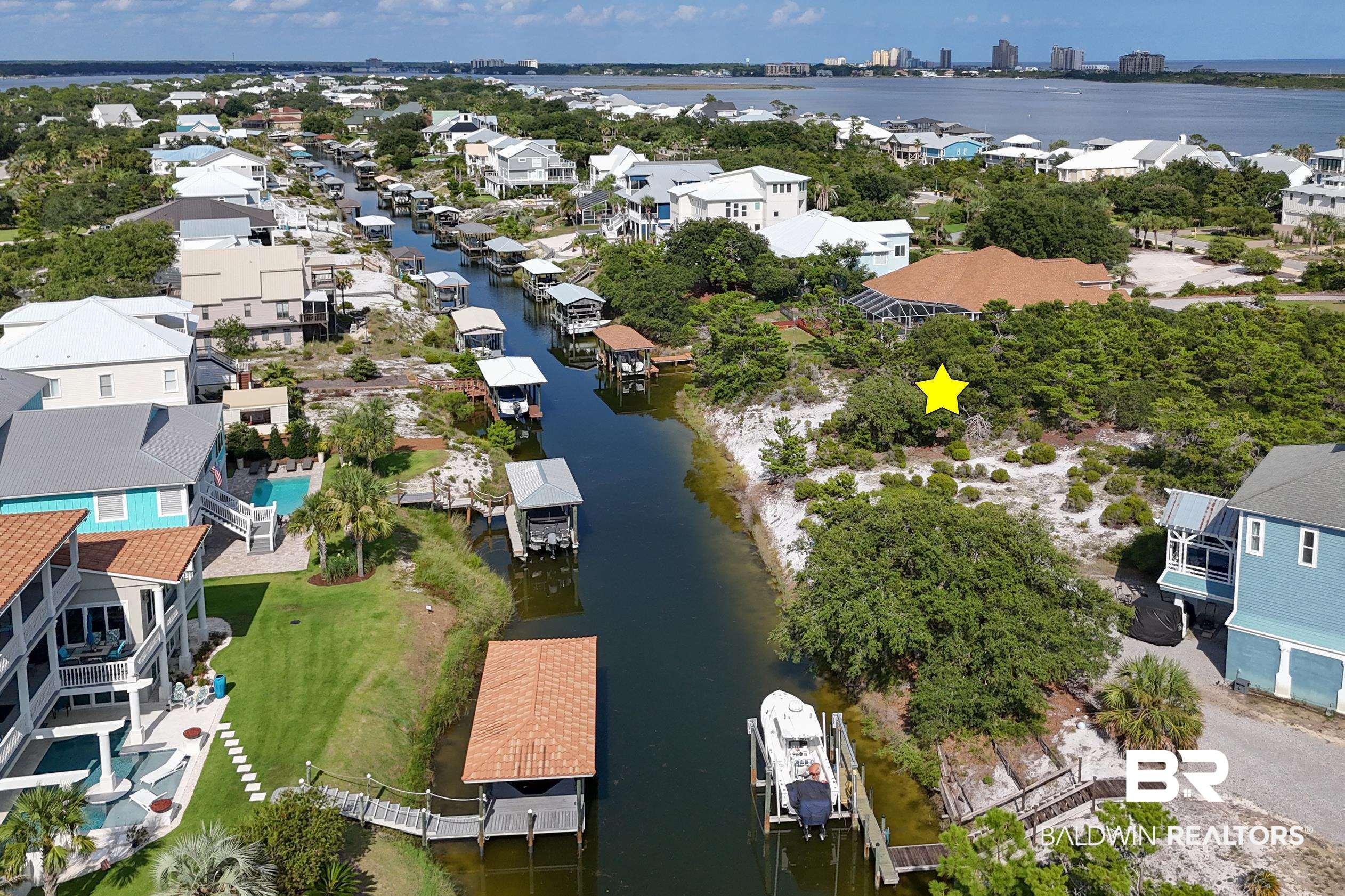 Image 1: Aerial perspective of suburban area with a large body of water