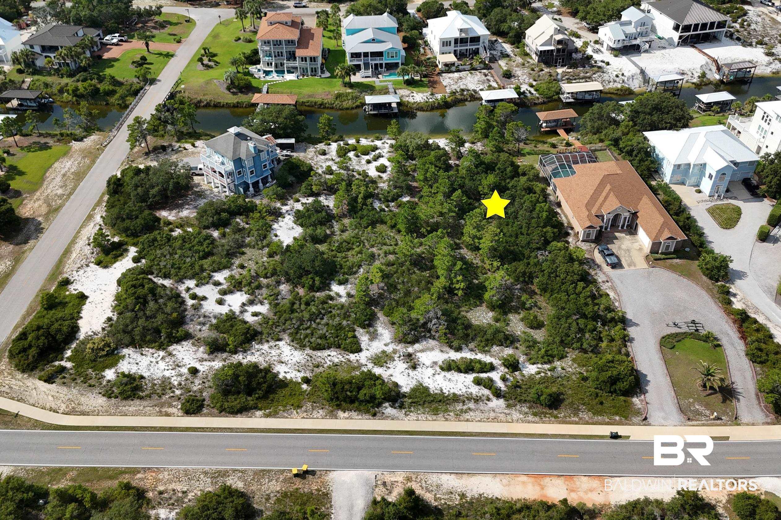Image 4: Aerial view of property's location with a large body of water