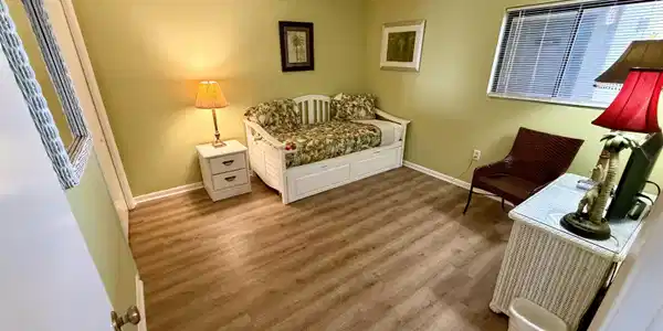 Image 3: Living area featuring wood finished floors and baseboards