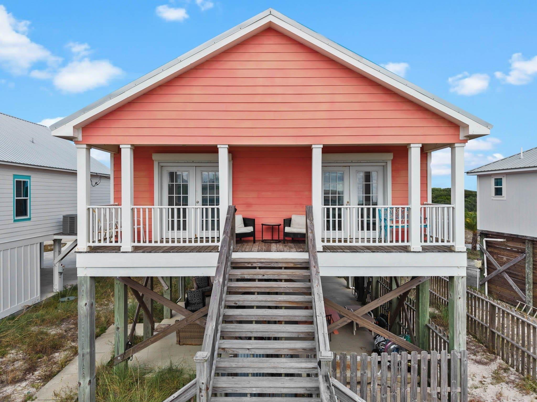 Image 2: Back of property featuring a porch, french doors, and stairway