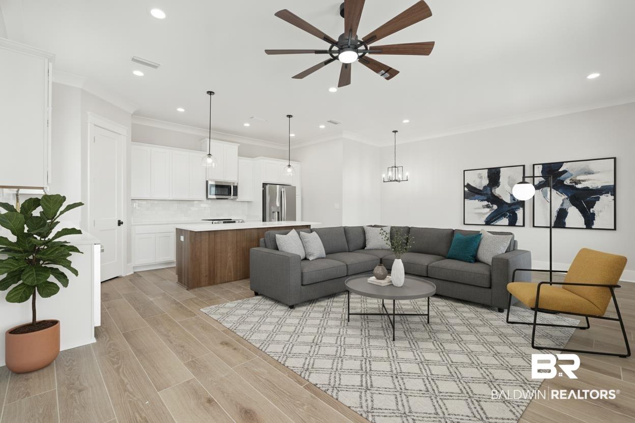 Image 2: Open-concept living space featuring wood-finish flooring, recessed lighting, and a contemporary ceiling fan