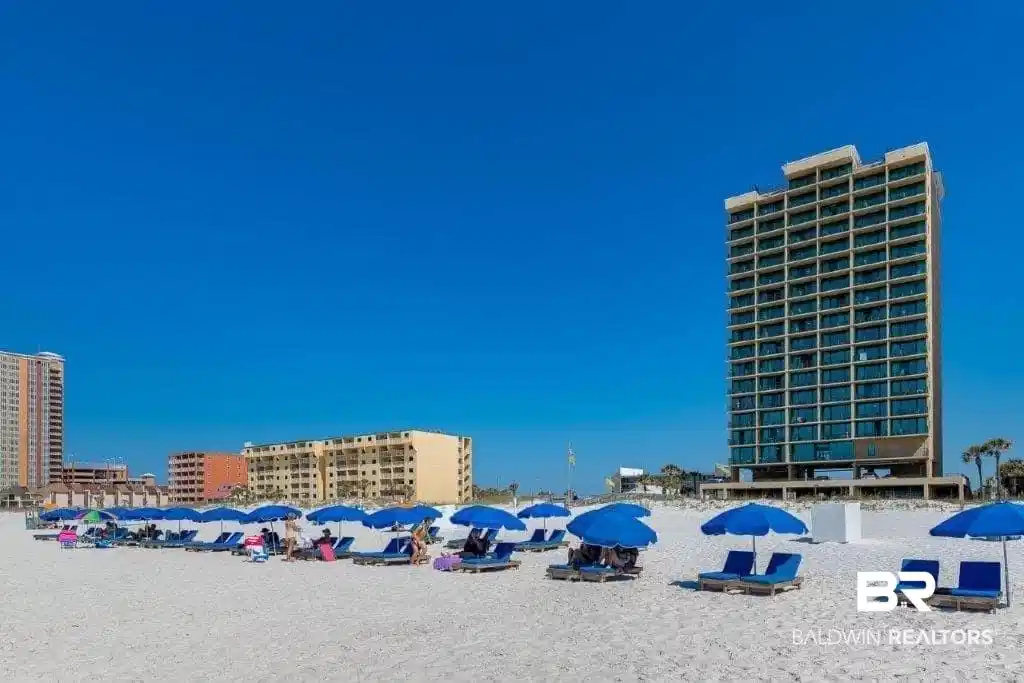 Image 1: Beachfront resort property featuring a multi-story building with extensive glazing