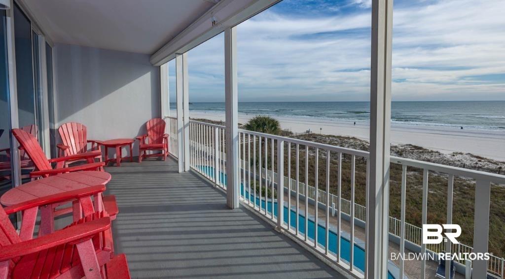 Image 3: Balcony featuring view of water and beach