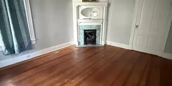 Image 4: Unfurnished living room with dark wood-type flooring, a tile fireplace, and ornamental molding