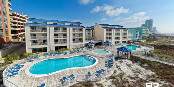 Image 4: Community pool with a community hot tub and a patio area