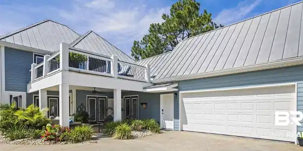 Image 3: View of front of property with a standing seam roof, a balcony, concrete driveway, and ceiling fan