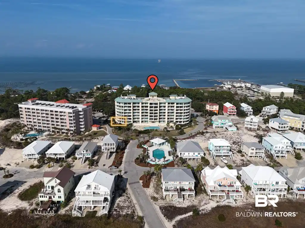 Image 1: Drone / aerial view of a nearby body of water and apartment complex