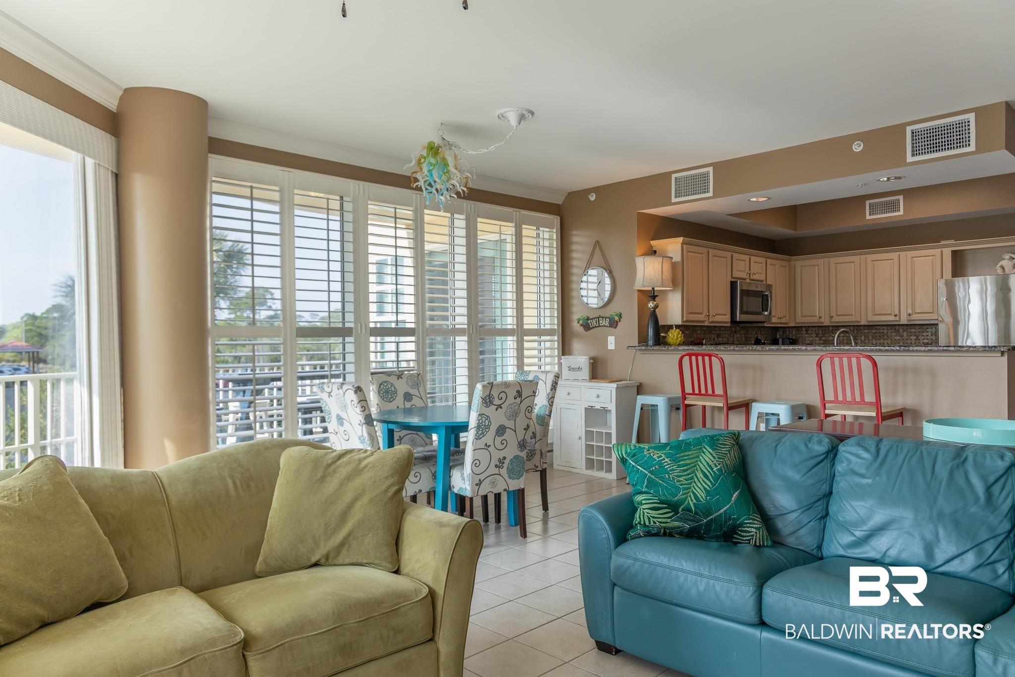 Image 4: Living area featuring light tile patterned flooring