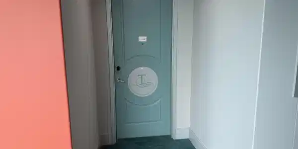 Image 3: Powder blue entry door with circular inset detailing, electronic key pad, and brushed nickel hardware