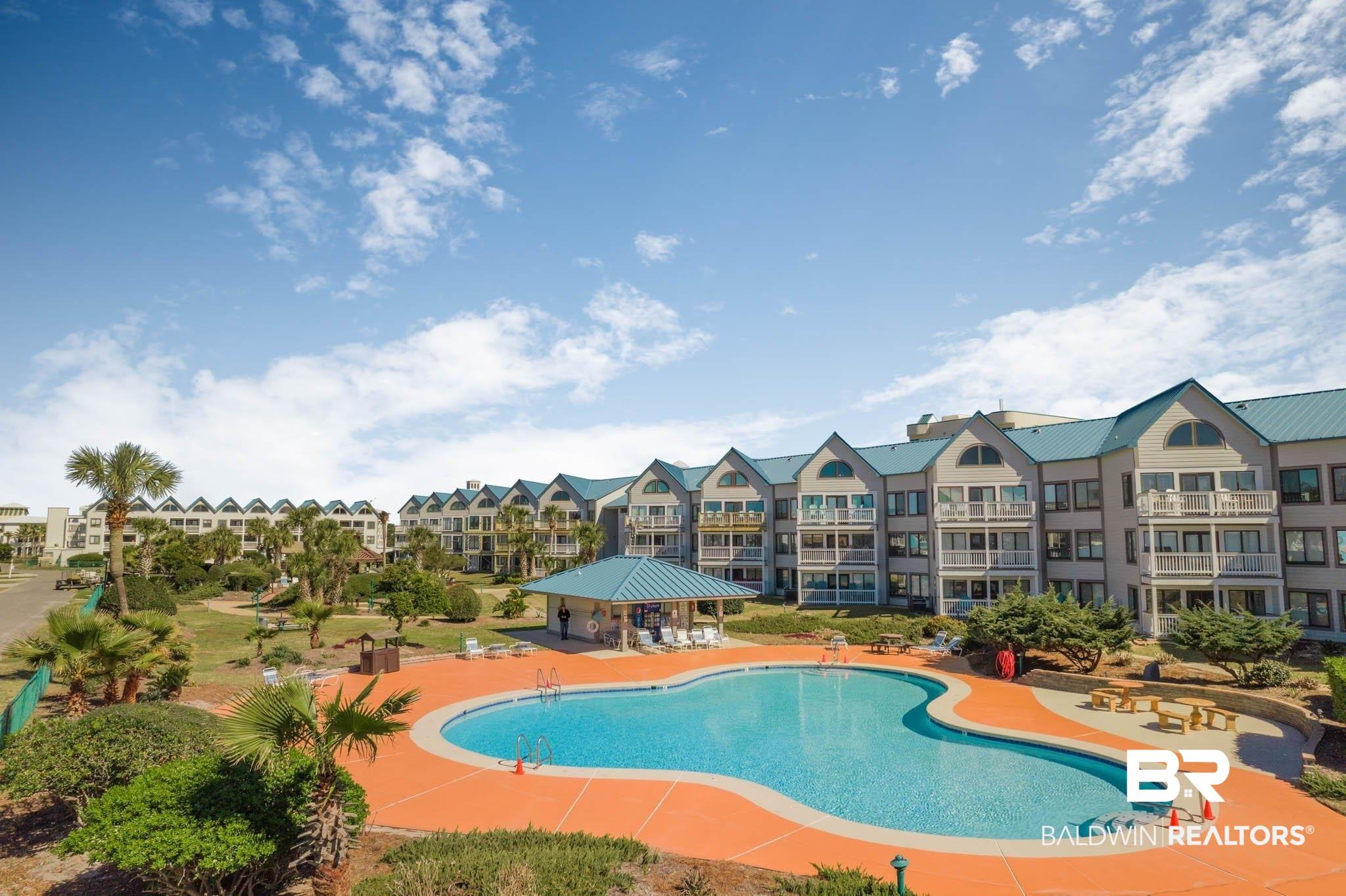 Image 2: Community pool featuring a patio area and a residential view