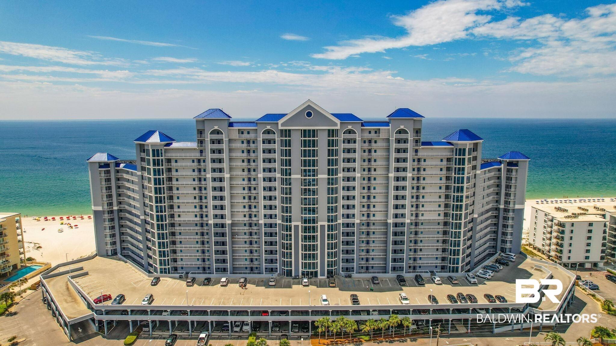 Image 2: Aerial view of apartment complex and unending shoreline