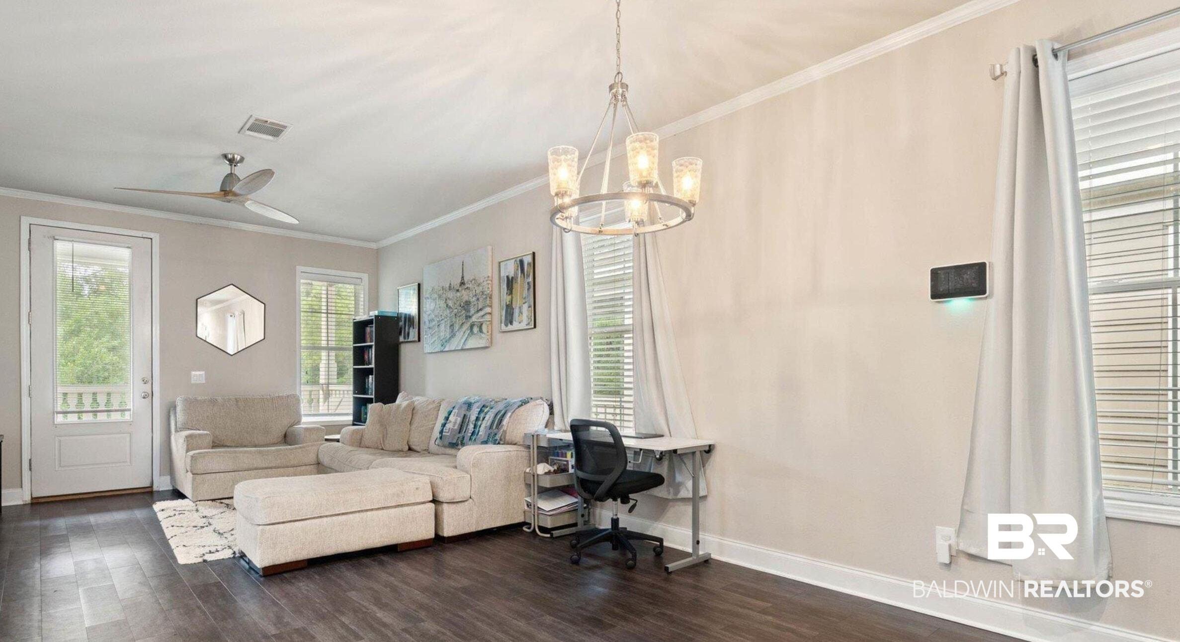 Image 3: Living area featuring crown molding, a ceiling fan, dark wood-style flooring, a chandelier, and a desk