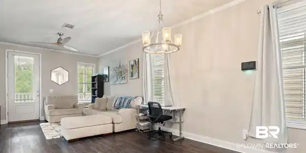 Image 3: Living area featuring crown molding, a ceiling fan, dark wood-style flooring, a chandelier, and a desk