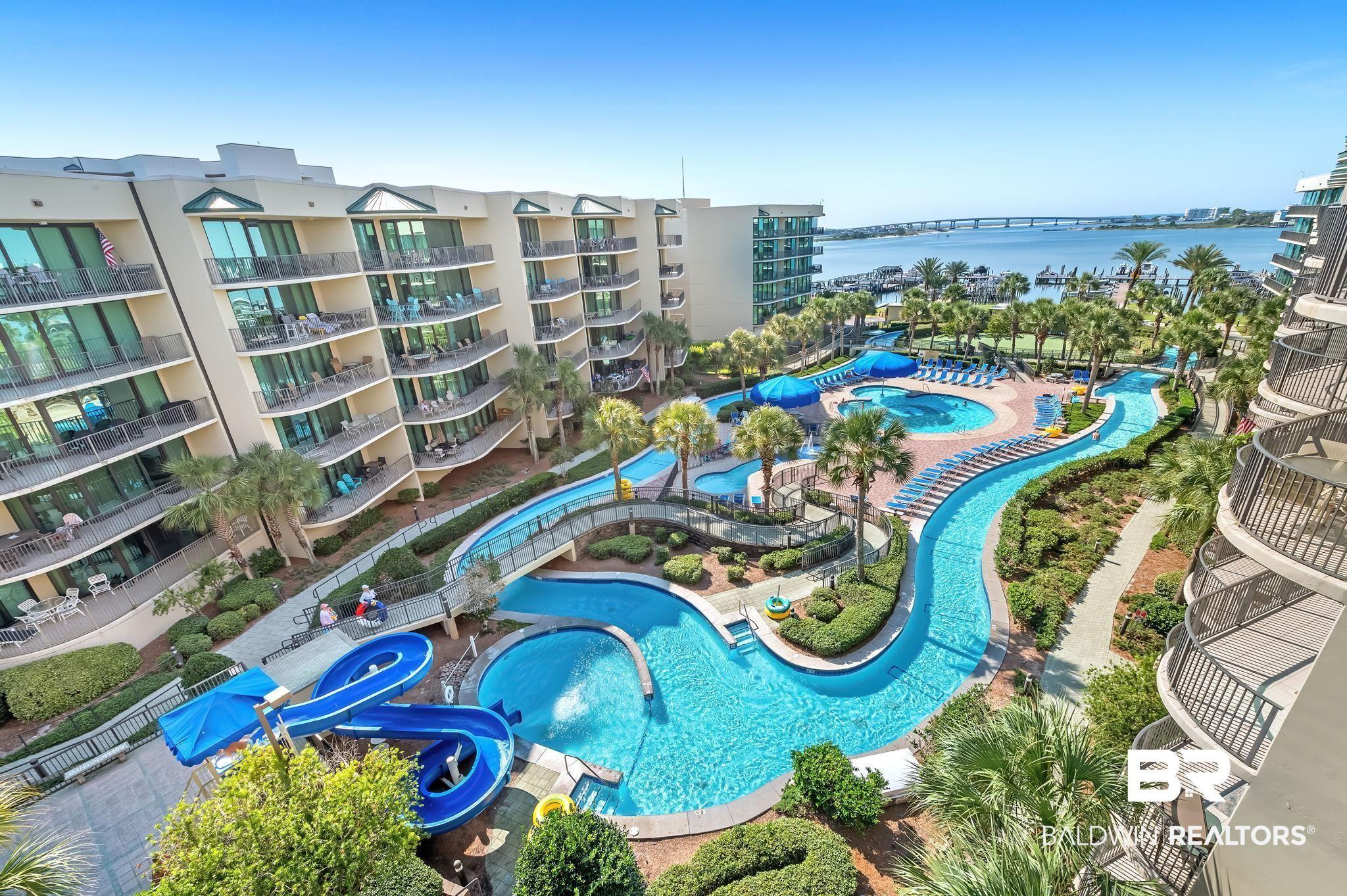 Image 1: Bird's eye view of apartment complex / building and a large body of water
