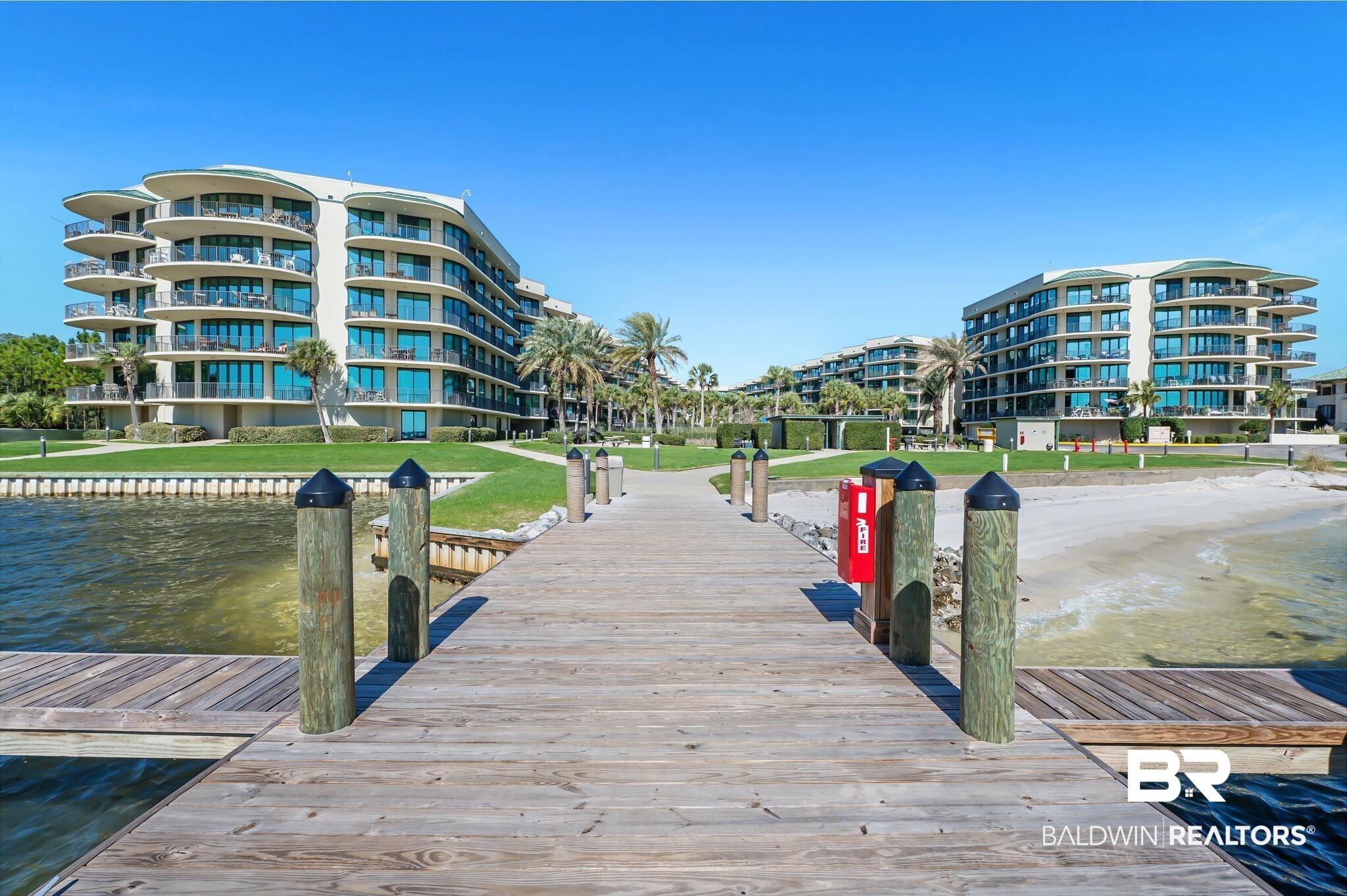 Image 2: Dock area with a water view and a yard