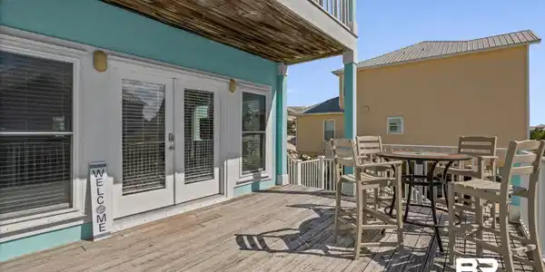 Image 2: Front Deck with french doors and outdoor dining space