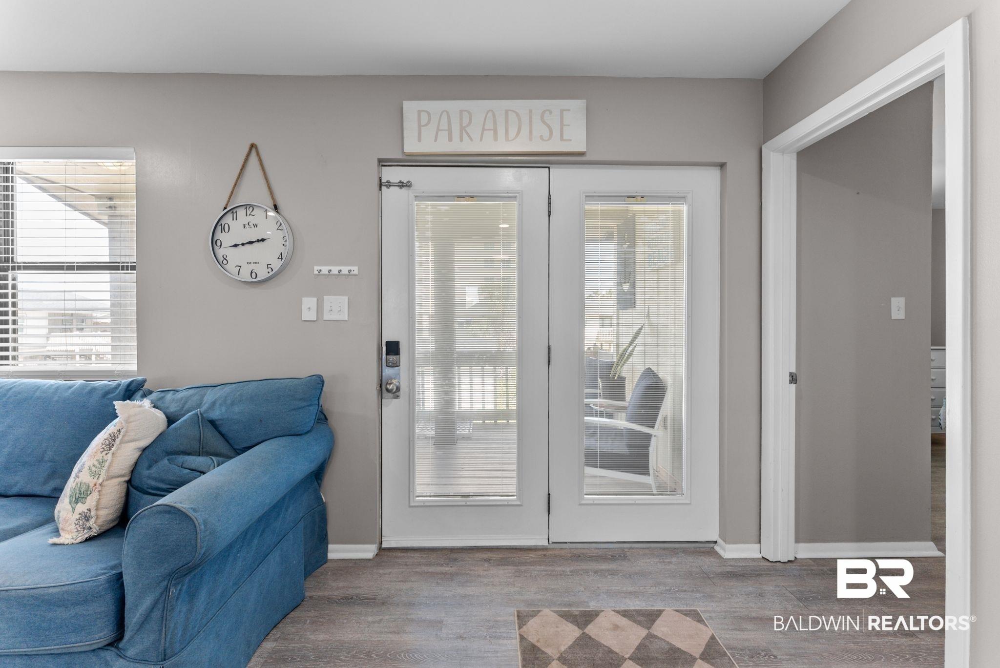 Image 2: Doorway to outside with wood finished floors and plenty of natural light