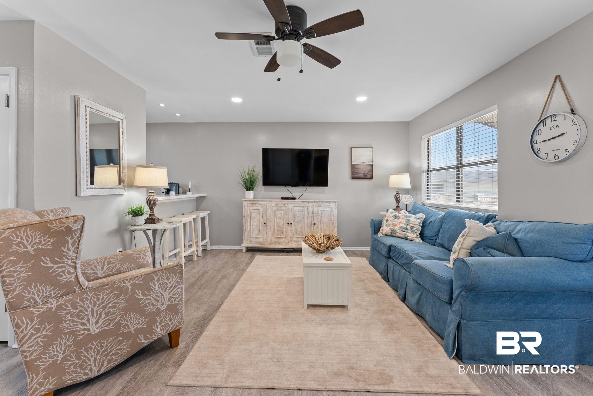 Image 4: Living area with ceiling fan, wood finished floors, and recessed lighting