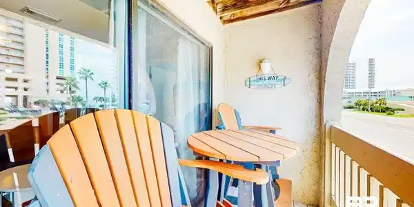 Image 2: Balcony with privacy wall, wood-plank flooring, and wood slat ceiling