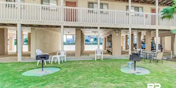 Image 3: Ground-level outdoor space featuring a grass lawn