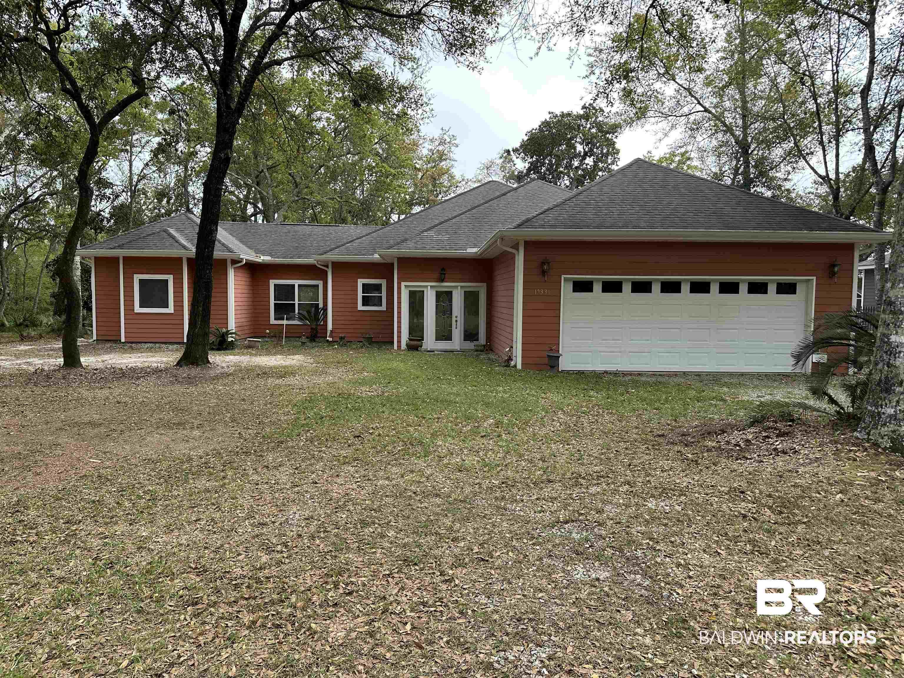Image 1: Ranch-style home with french doors, an attached garage, a shingled roof, and a front lawn