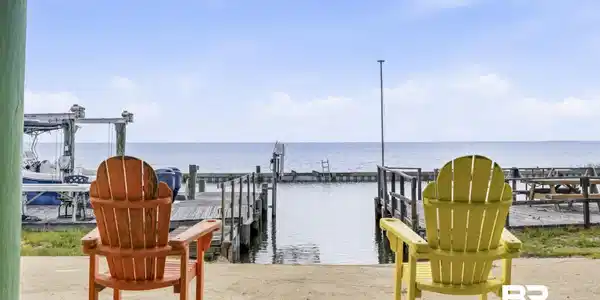 Image 4: Waterfront property featuring a private boat dock, boat lift, water access, and concrete patio