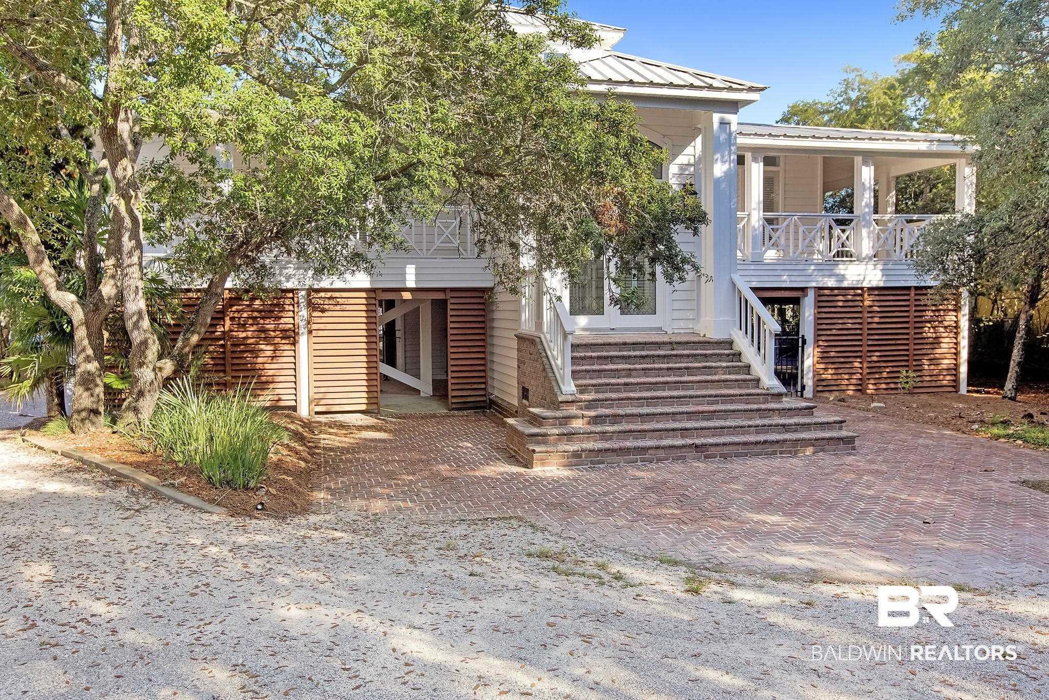 Image 2: View of front of home with stairway, a metal roof, and a porch