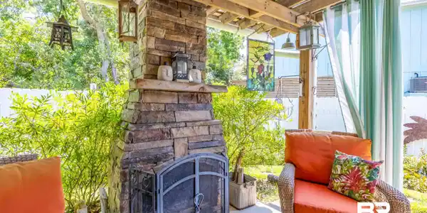 Image 2: View of patio featuring an outdoor stone fireplace