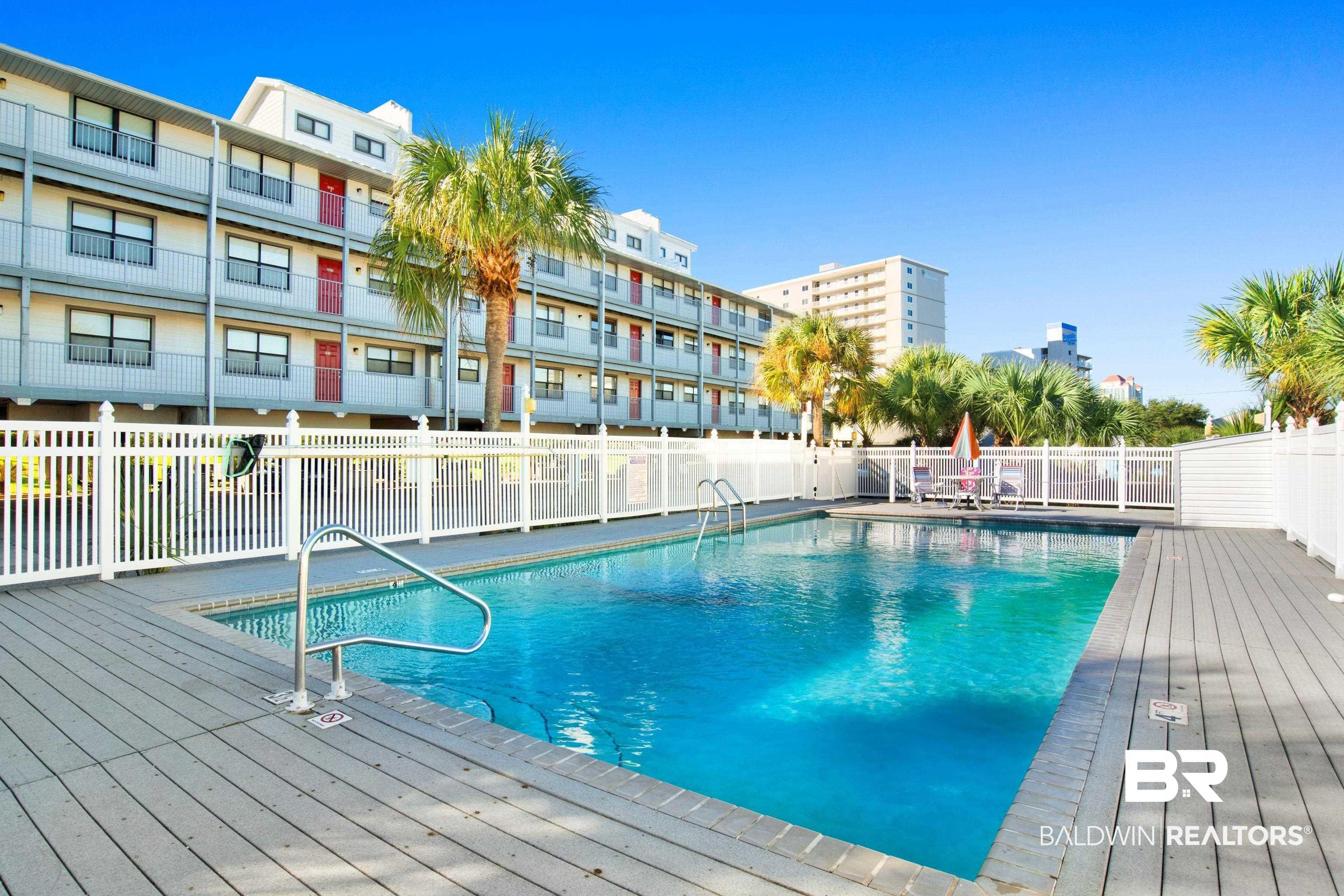 Image 2: Community pool with a patio