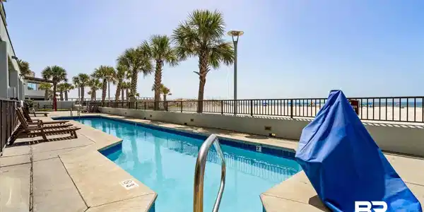 Image 3: Community pool with a patio area