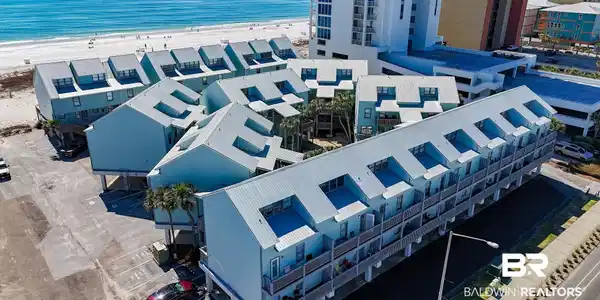 Image 2: Birds eye view of property with a water view and a view of the beach