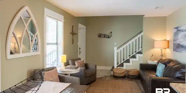 Image 3: Tiled living area with stairs and visible vents