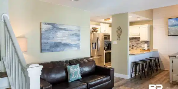Image 4: Living room featuring stairs, dark wood-style flooring, and visible vents