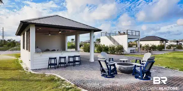 Image 2: View of patio / terrace with exterior bar, ceiling fan, stairs, and an outdoor fire pit