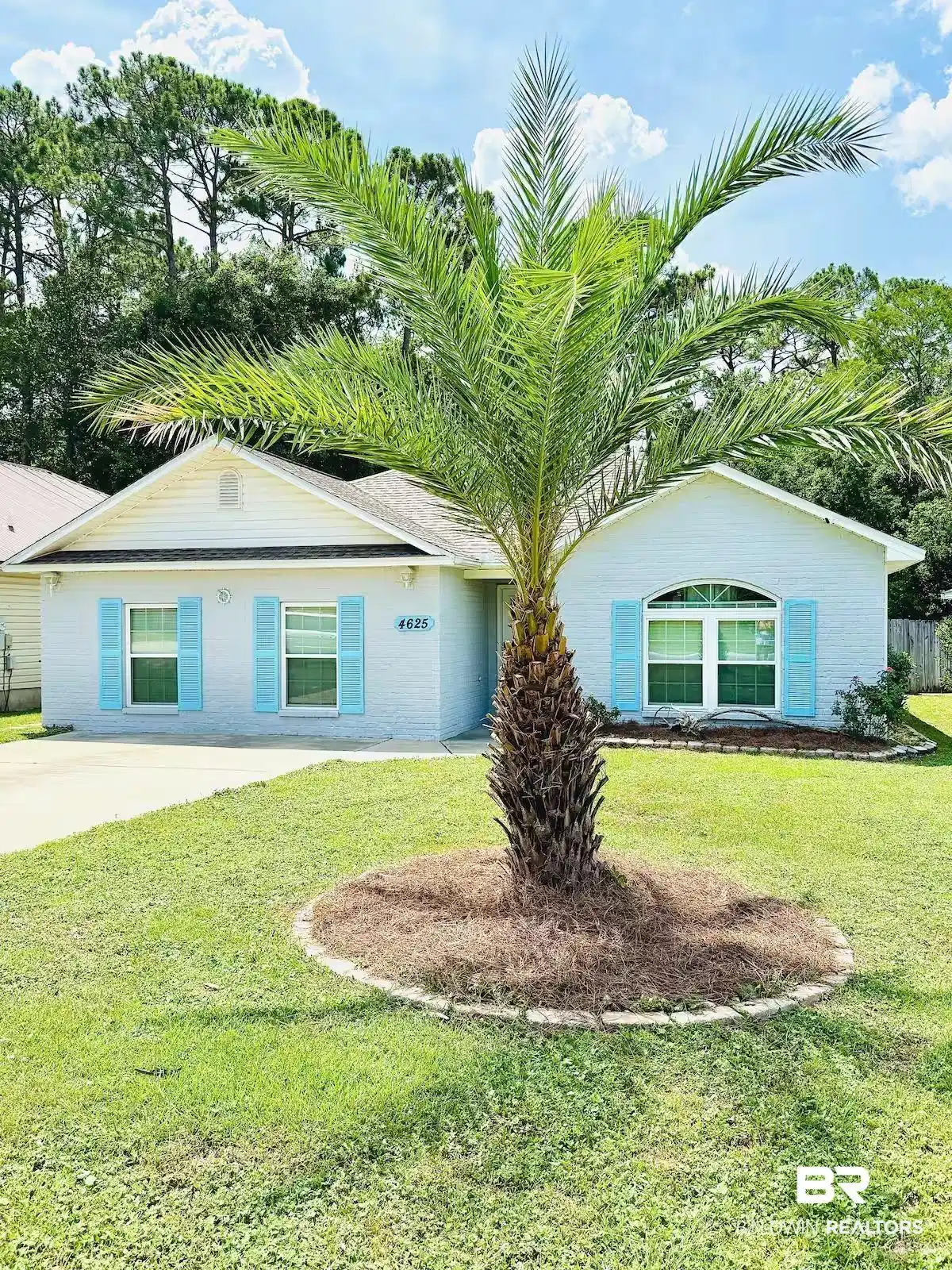 Image 1: Light blue exterior with white trim and contrasting aqua shutters