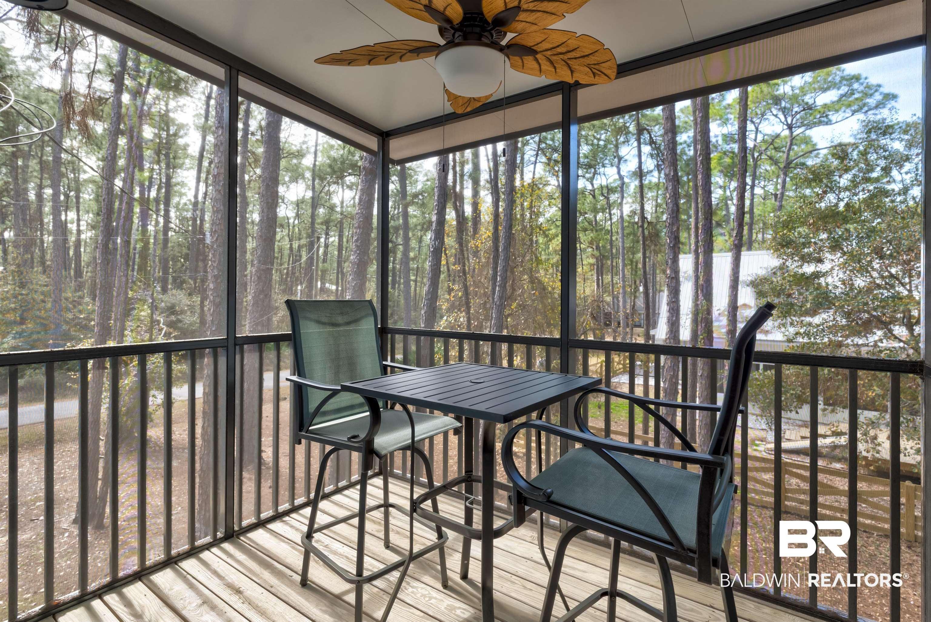 Image 4: Sunroom featuring ceiling fan, healthy amount of natural light, and view of wooded area