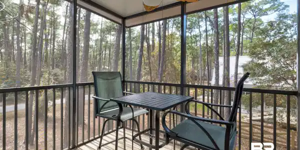 Image 4: Sunroom featuring ceiling fan, healthy amount of natural light, and view of wooded area