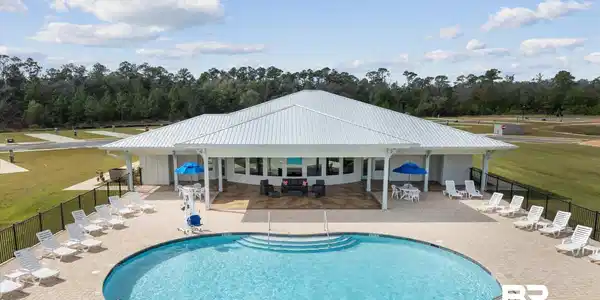 Image 4: Community pool with a patio area
