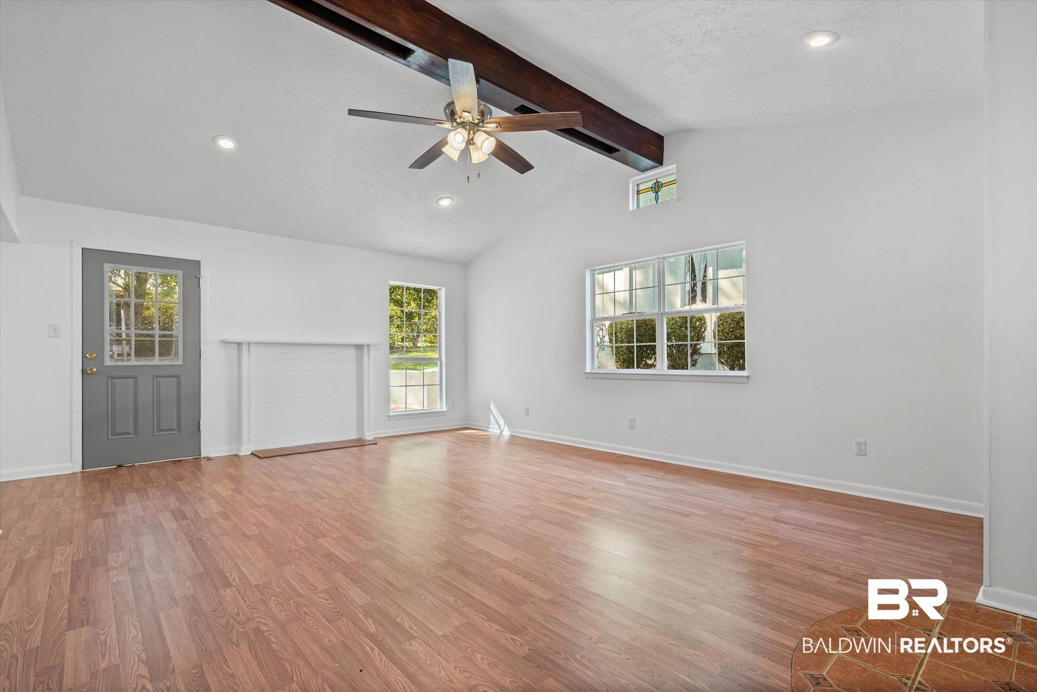 Image 4: Living area with wood flooring, lots of natural light!