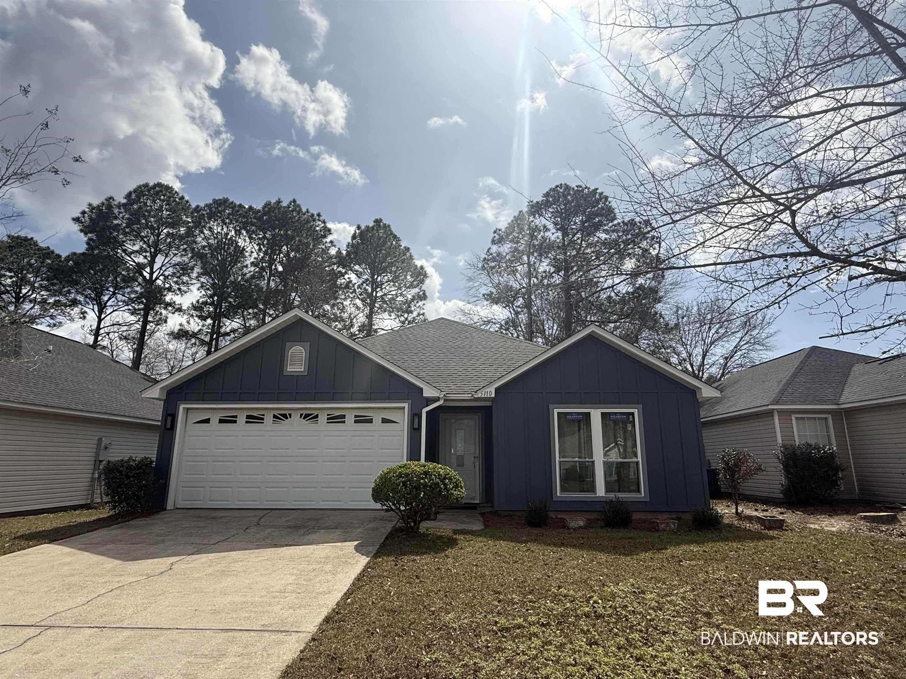 Image 1: Single story home featuring board and batten siding, driveway, an attached garage, and roof with shingles