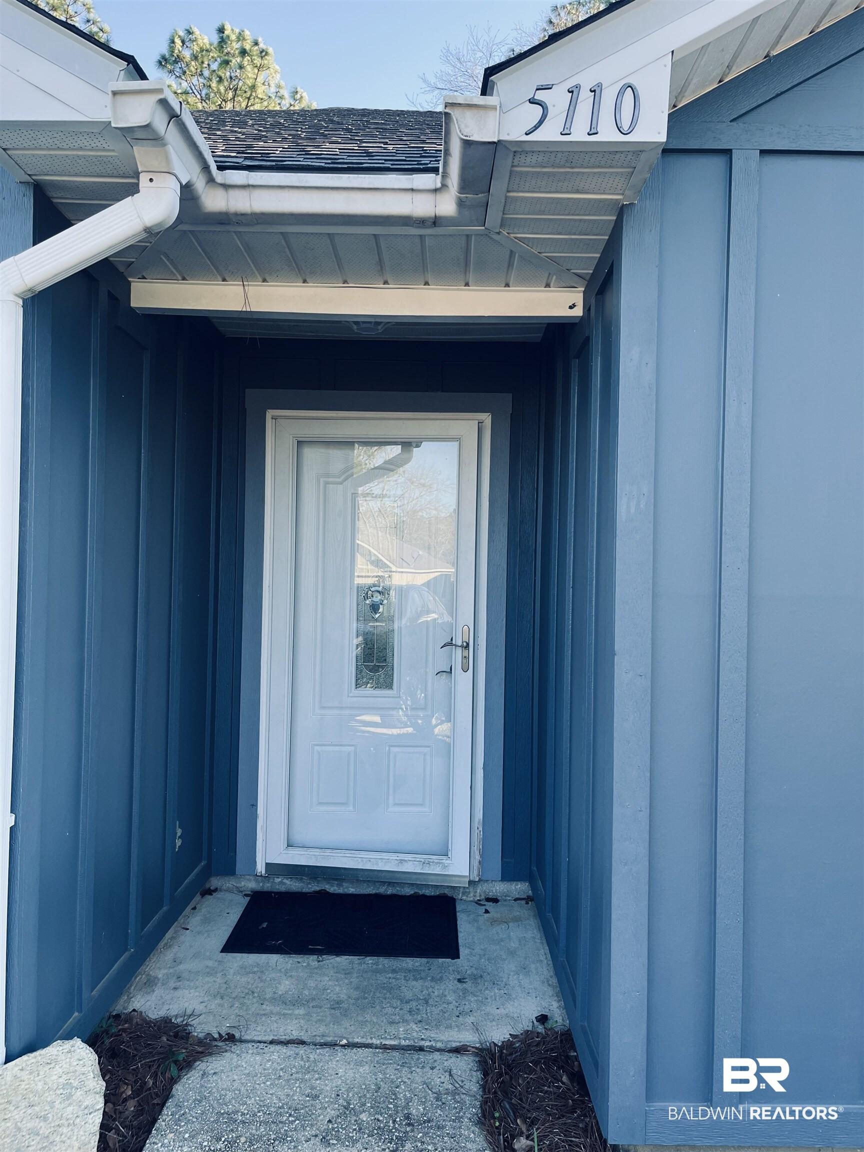 Image 3: Entrance to property with board and batten siding