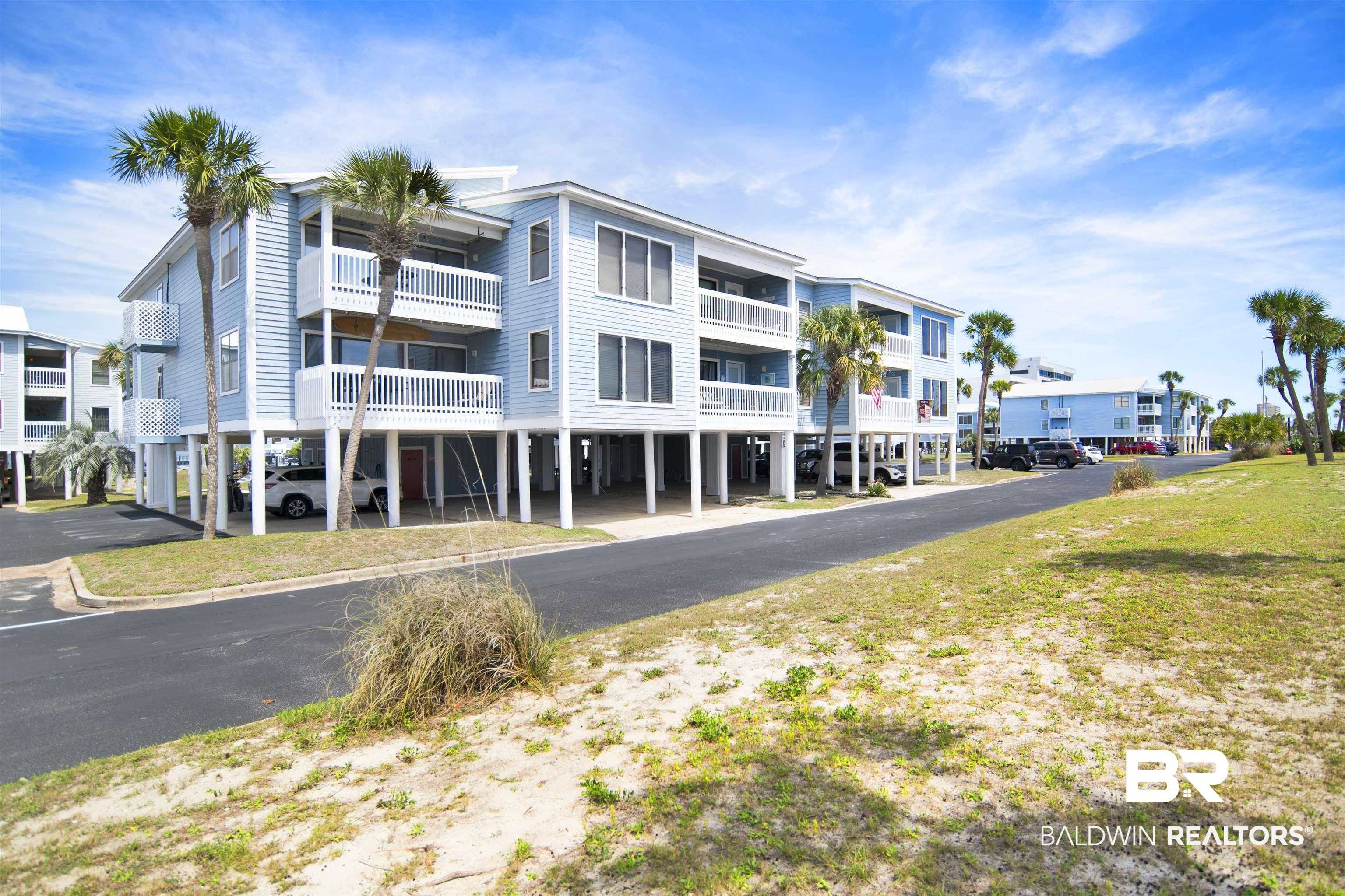 Image 2: View of apartment building / complex featuring a carport