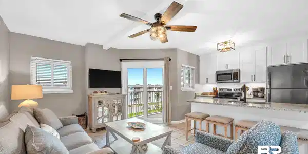 Image 4: Open-concept living area with tile flooring and a ceiling fan